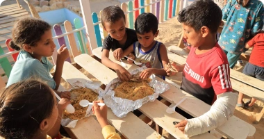 Children enjoying a nutritious meal provided by Giving Hands Canada’s Palestine Orphan Sponsorship Program.